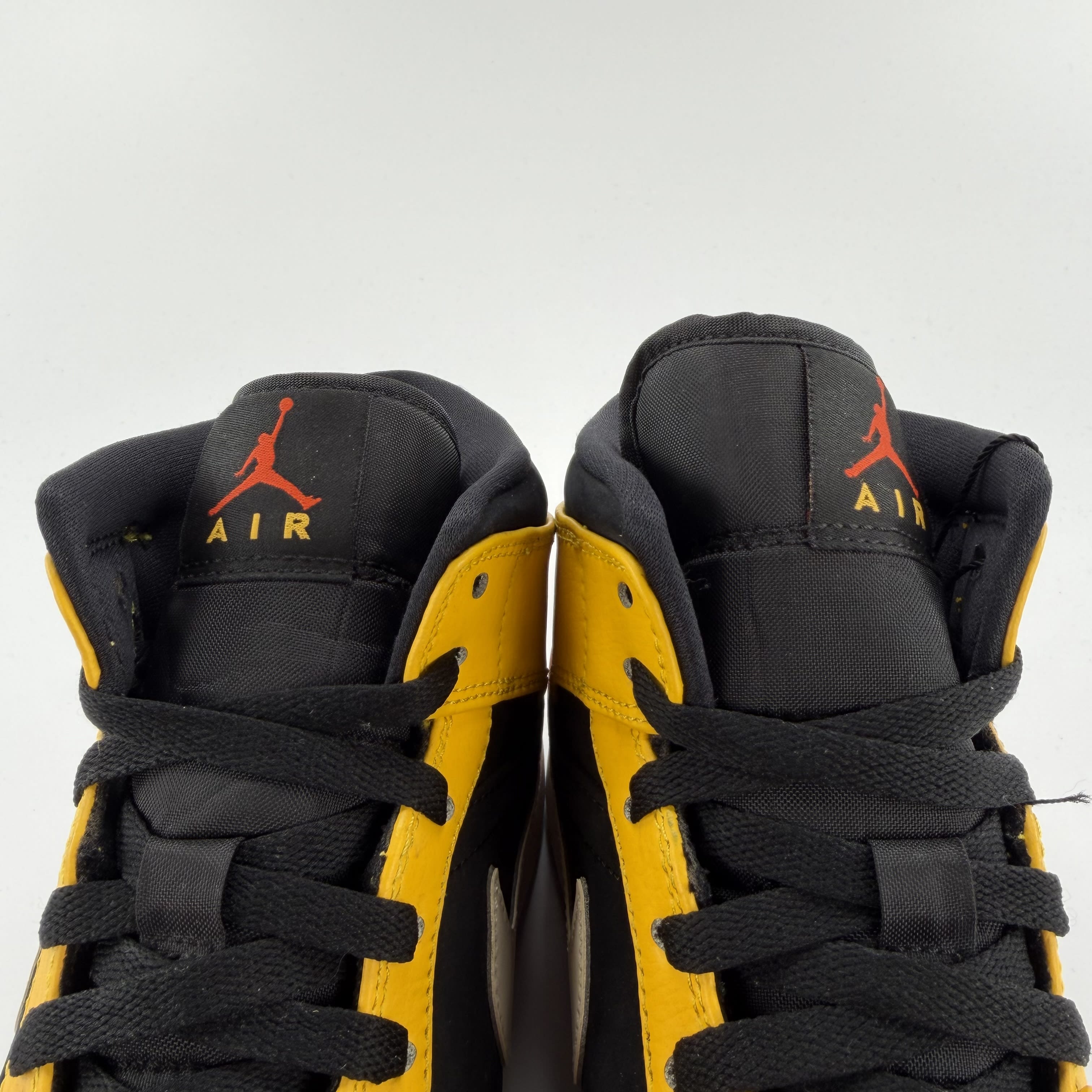 711457 Jordan 1 Mid Black Amarillo Orange